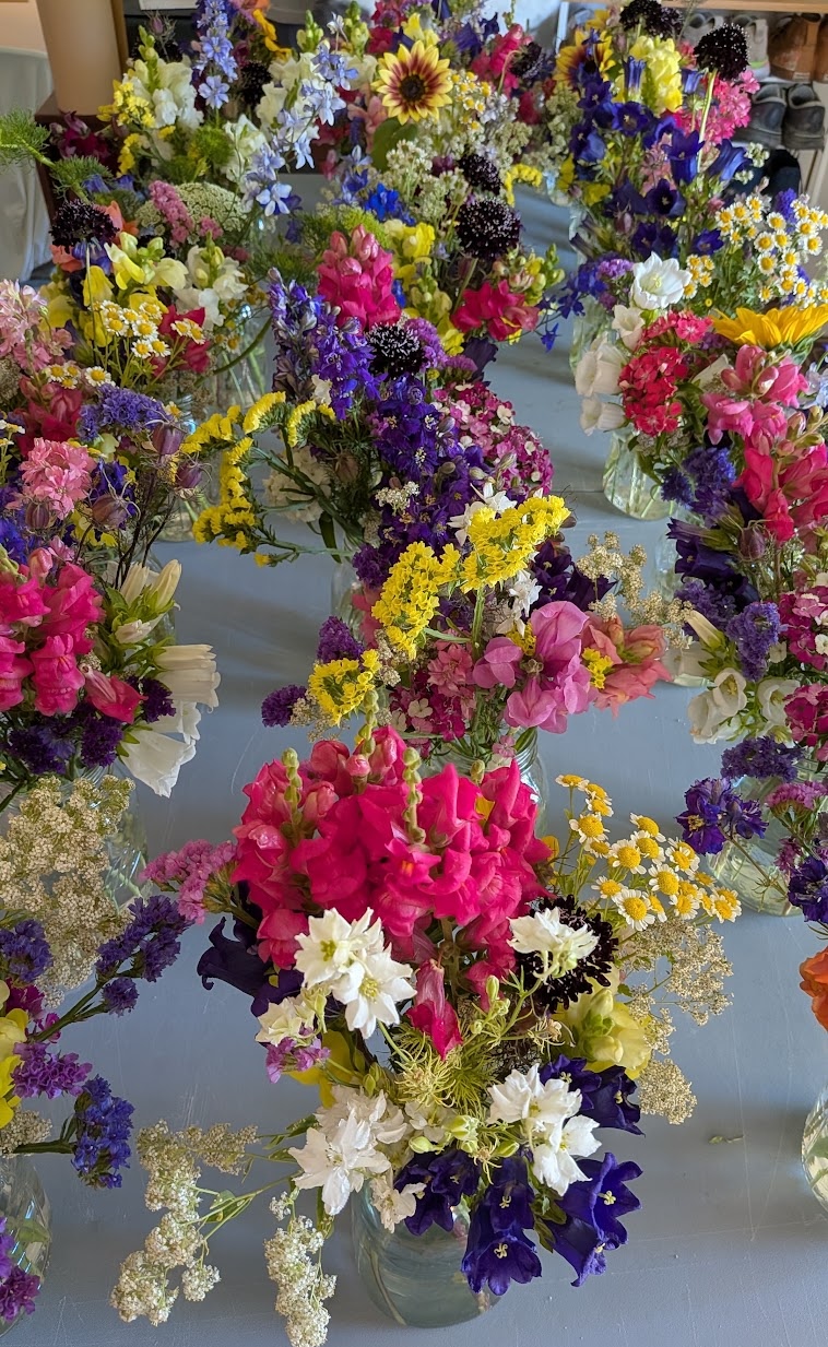 Dozens of mixed bouquets in glass jars, seen from above